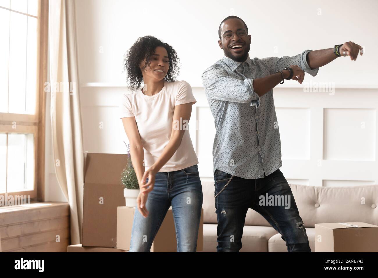 Happy millennial african american couple dancing in living room Stock ...