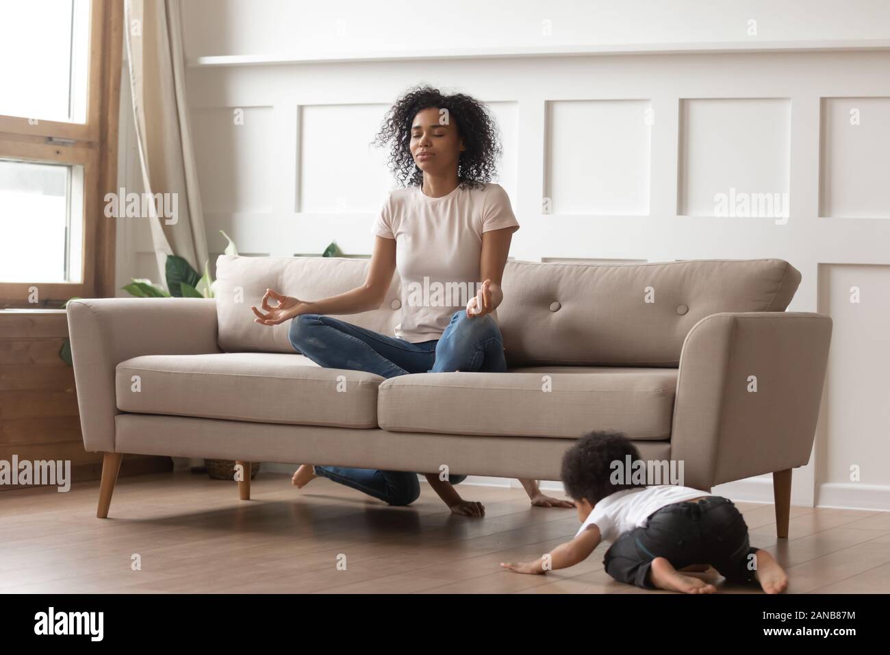 Cute noisy children having fun while mom meditating. Stock Photo