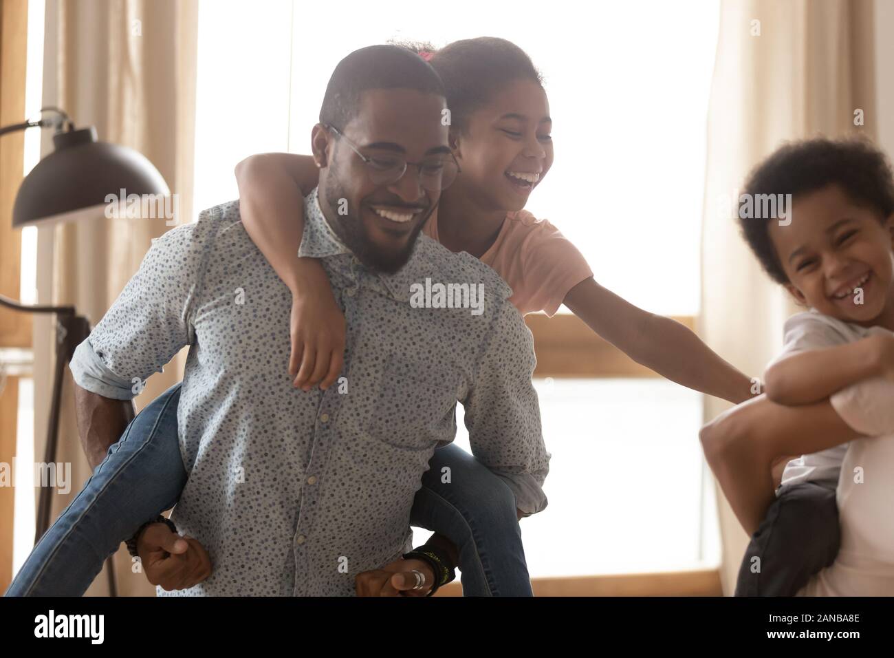 Close up happy black father with daughter on back Stock Photo - Alamy