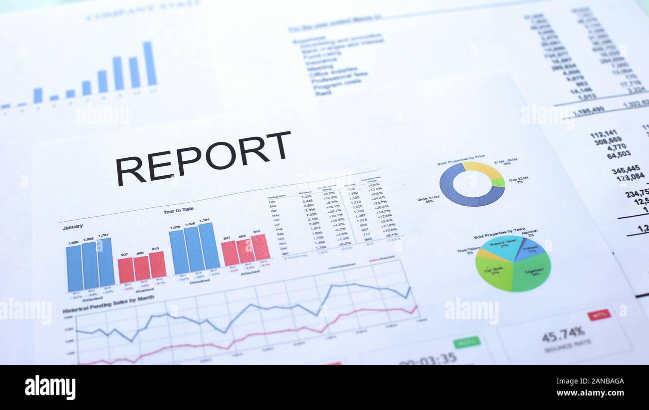 Report lying on table, graphs charts and diagrams, official document ...