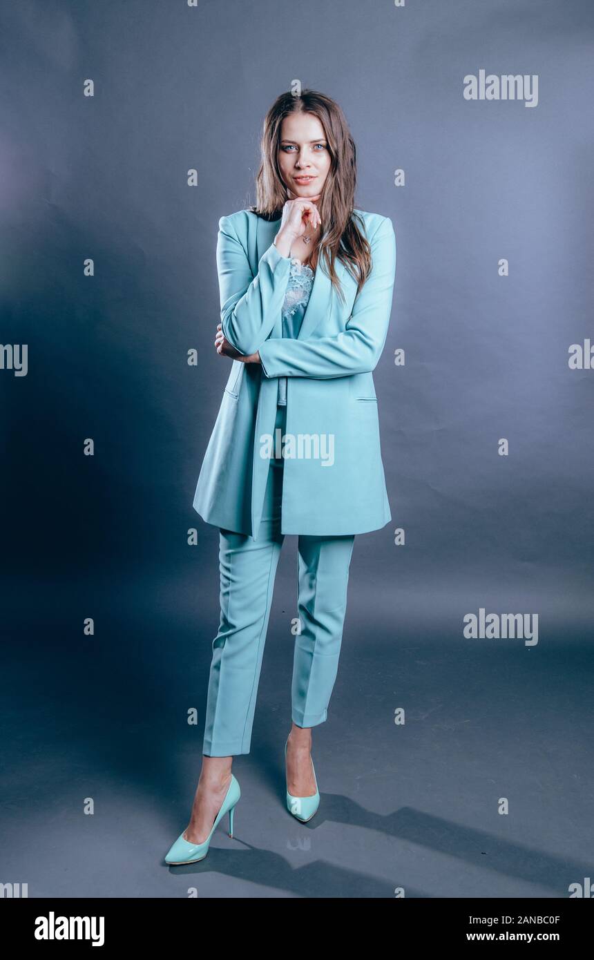 Portrait of young business woman in blue suit. Studio dark shot Stock ...