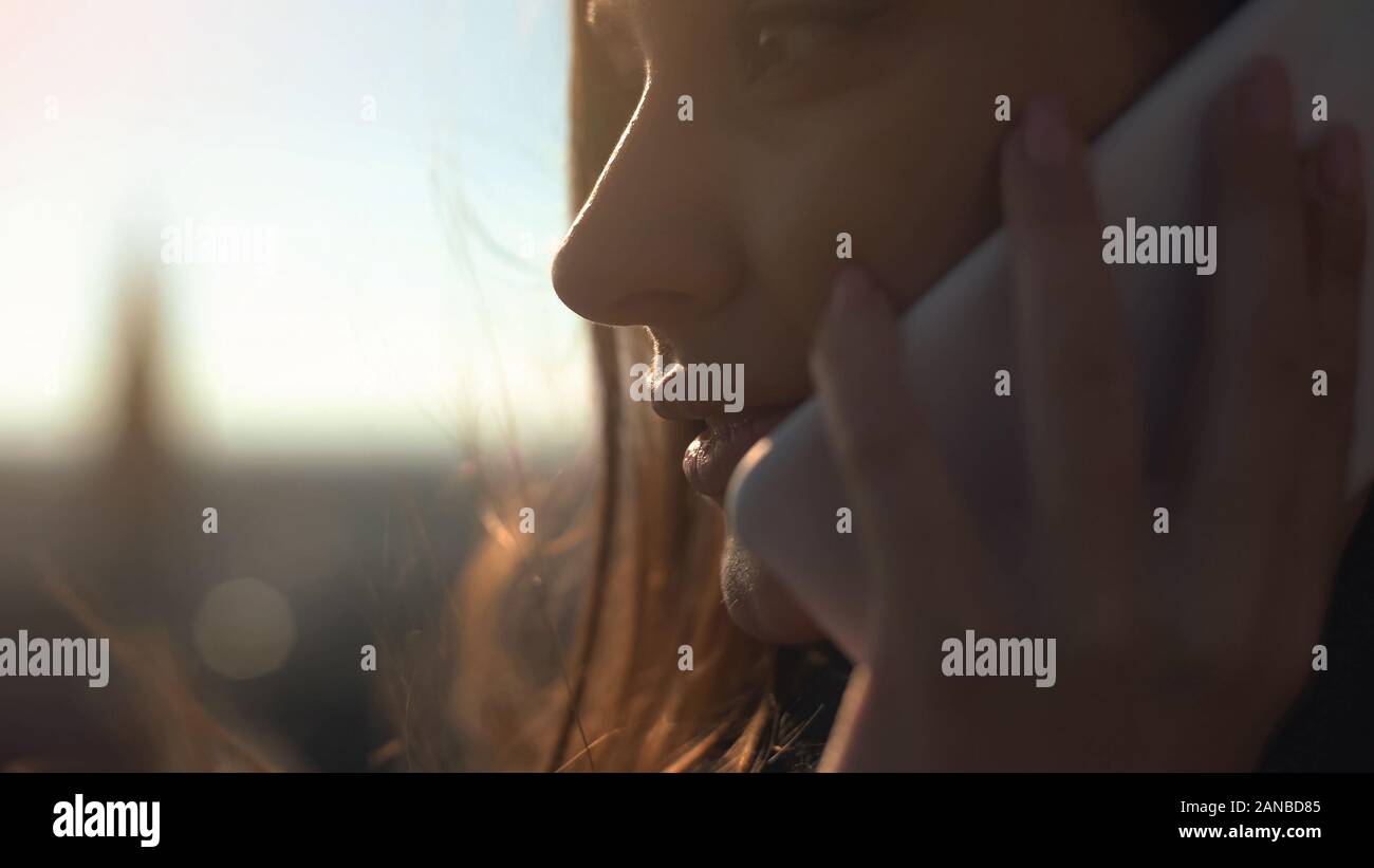 Pretty smiling lady talking cellphone with friend standing on skydeck connection Stock Photo