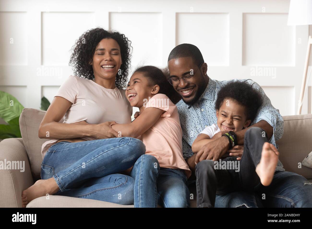 Smiling black family with kids having fun at home Stock Photo - Alamy