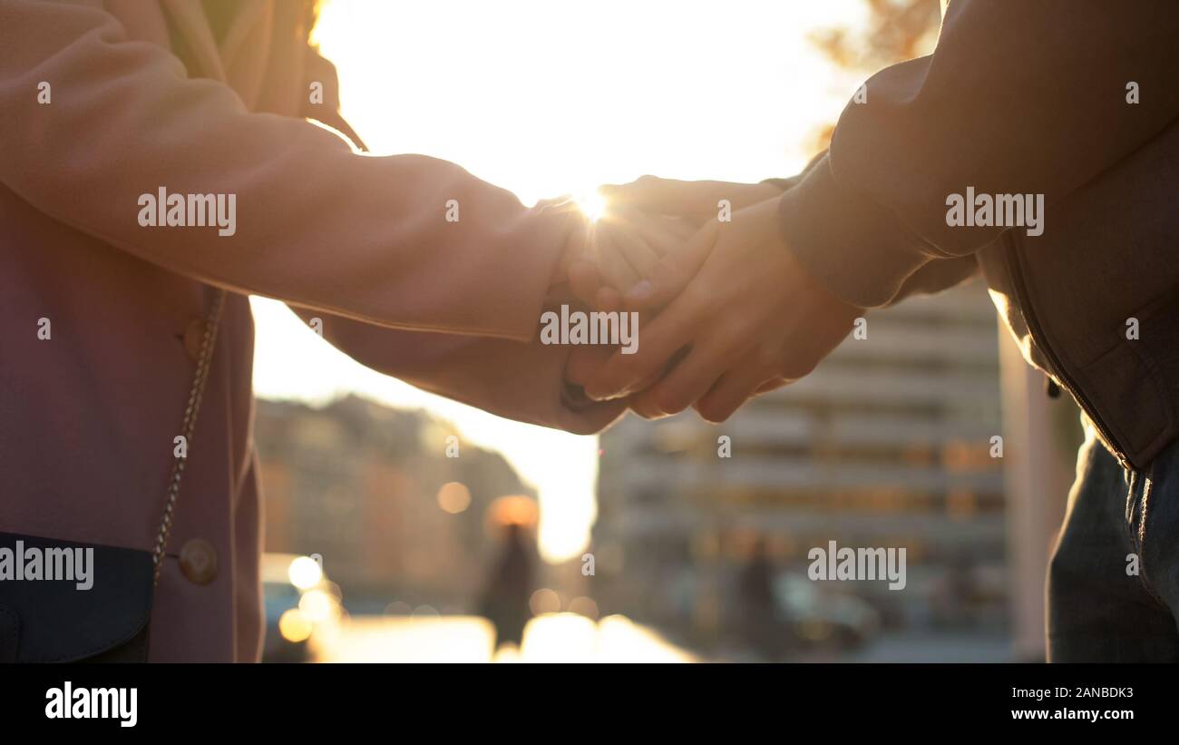 Woman and man holding hands, love relationship, romantic date in big ...