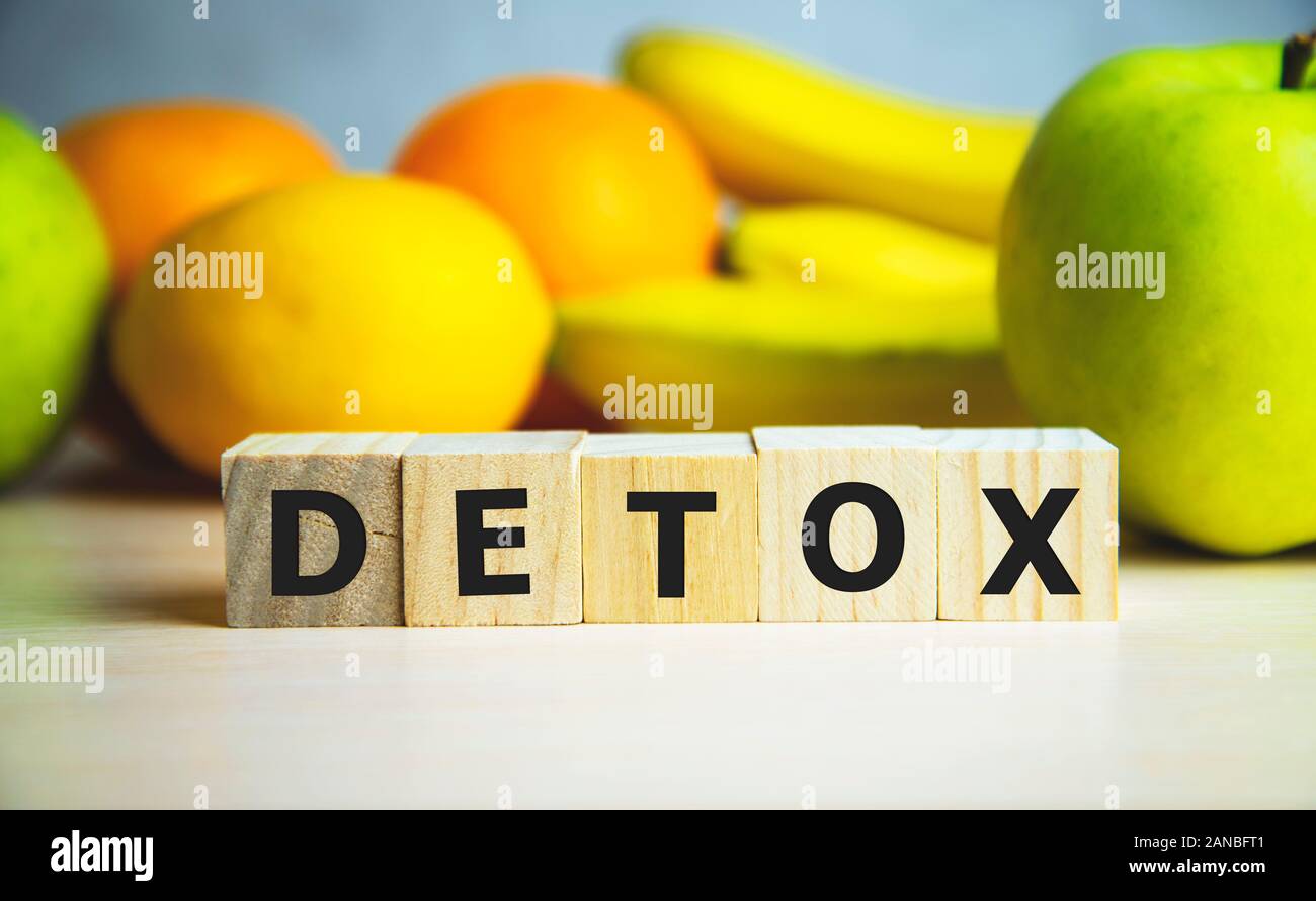 Detox text on a wooden cubes on a background with fruits Stock Photo