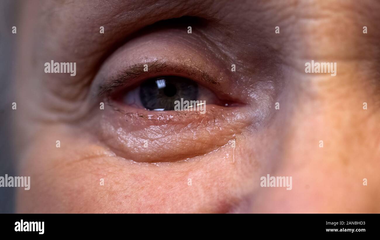Eye of old wrinkled person close-up, deep wisdom and life experience, nostalgia Stock Photo