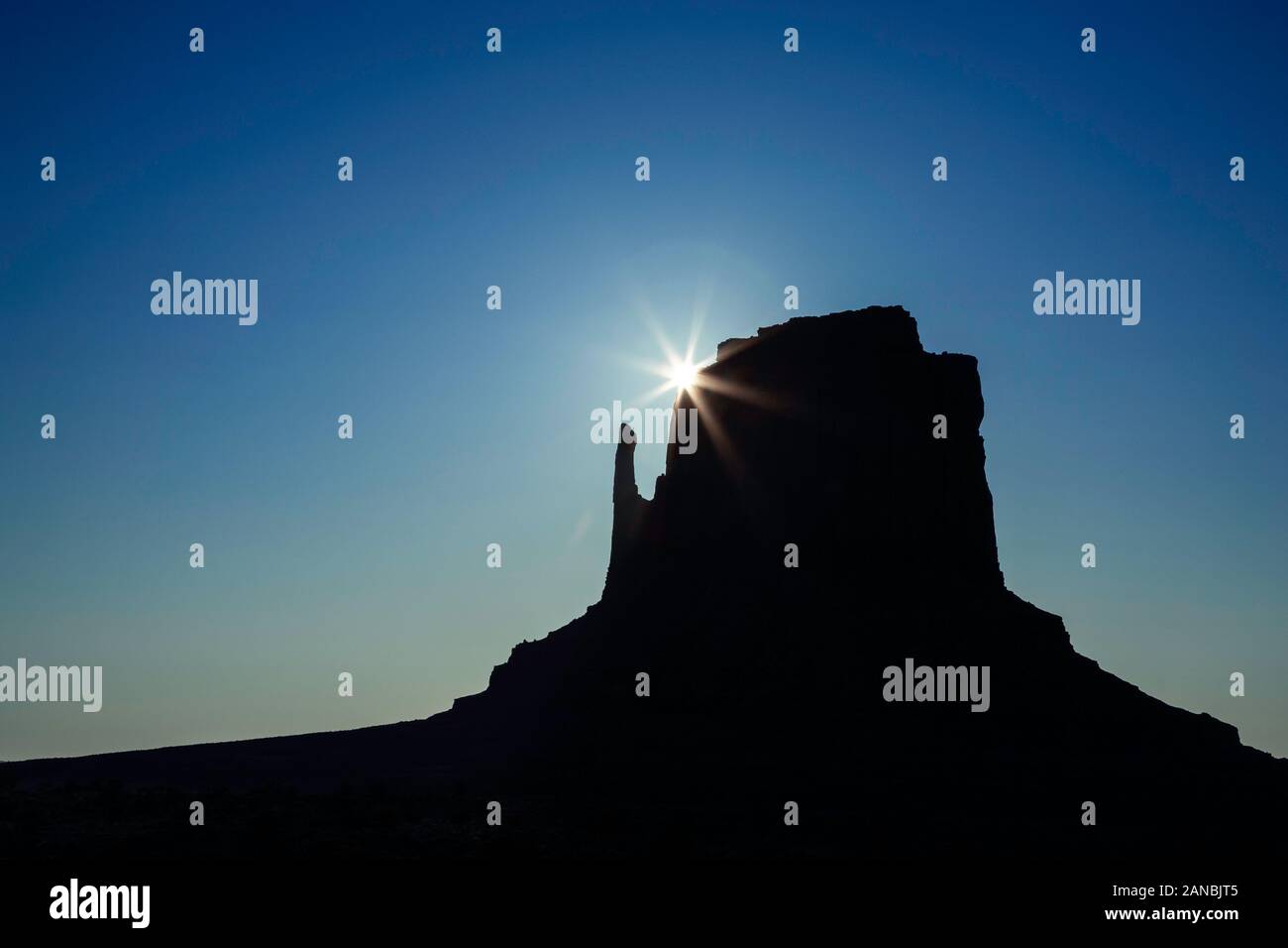 East Mitten and sunburst, Monument Valley, Arizona and Utah border, USA Stock Photo