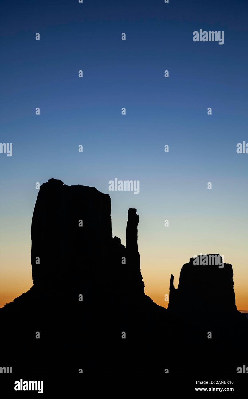 West Mitten silhouetted against morning sky, Monument Valley, Arizona and Utah border, USA Stock Photo