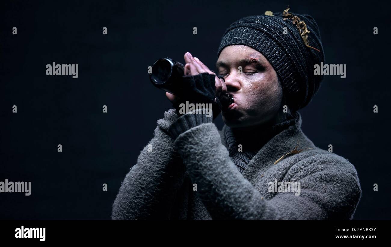 Alcohol addicted homeless with puffy face drinking beer, problem disappointment Stock Photo