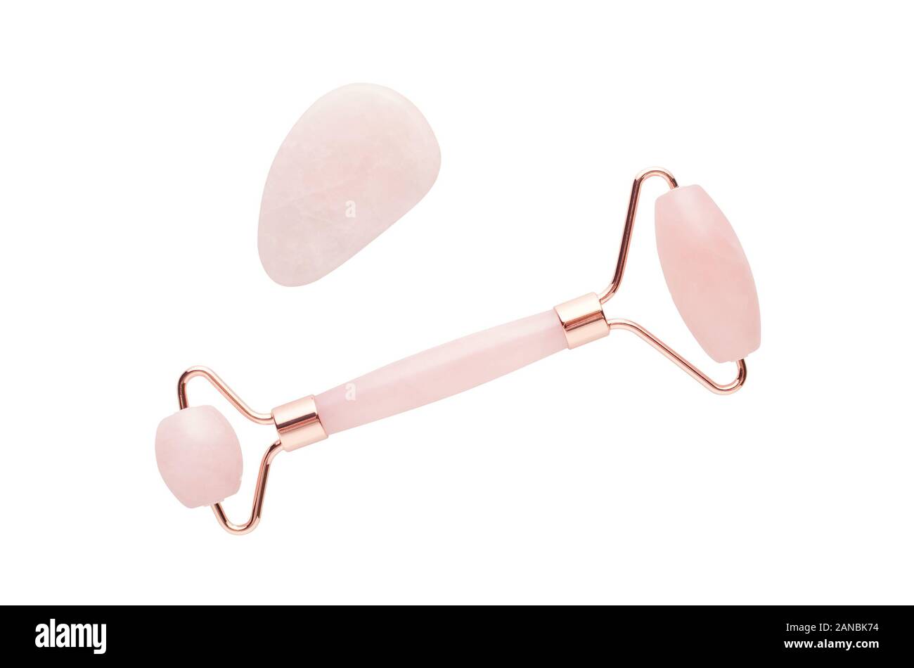 rose quartz facial roller and massage stone gua sha isolated on white