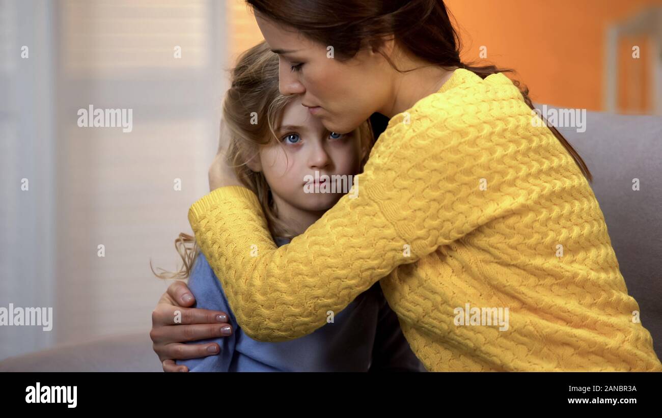 Upset mother hugging shocked daughter, feeling pain of relative loss, trouble Stock Photo