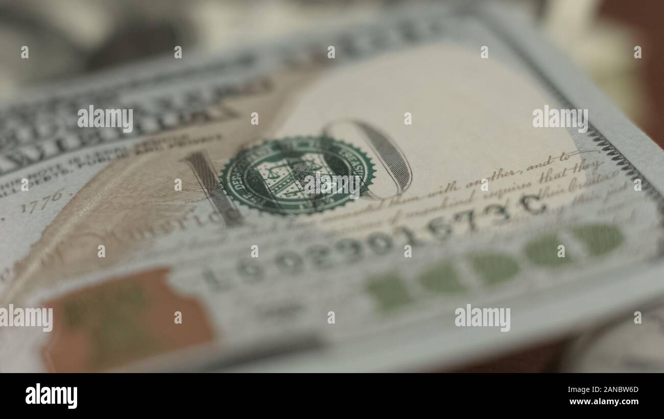 Counterfeit money detection, one hundred dollar bill closeup, banking