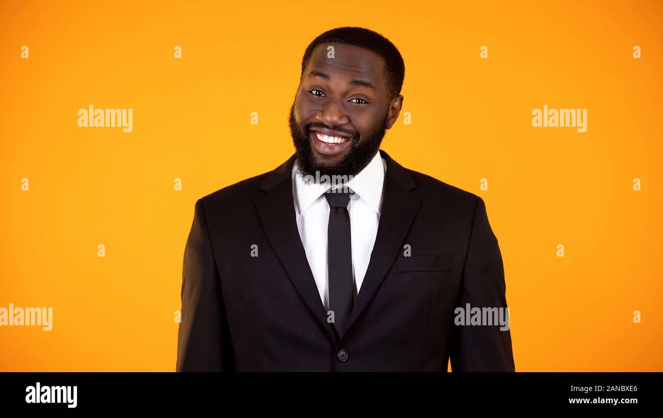 Black businessman smiling to camera, salesman making proposition