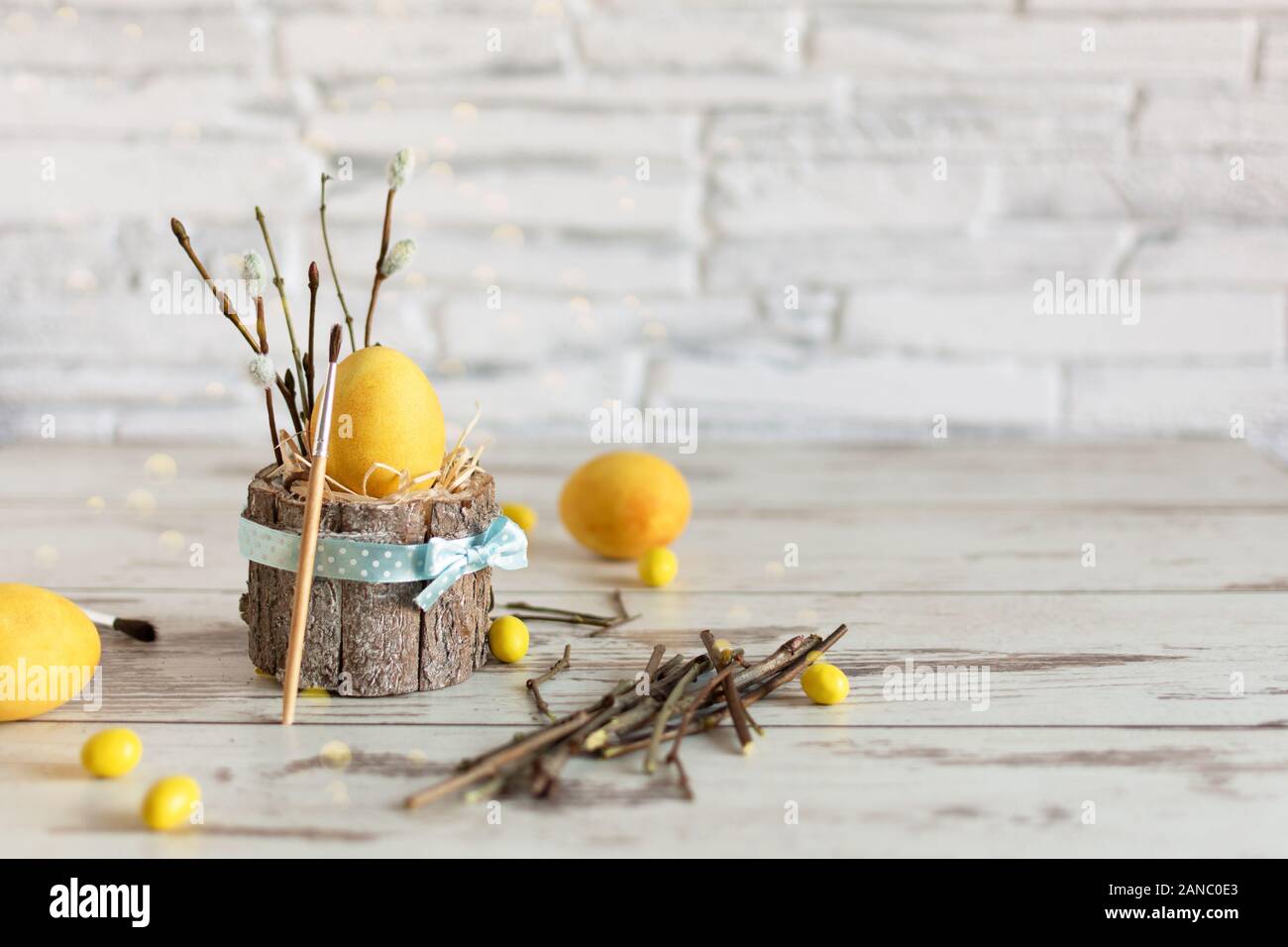 Yellow colored Easter eggs on wooden table. Happy Easter time. Creative Easter decoration. Copy space. Stock Photo