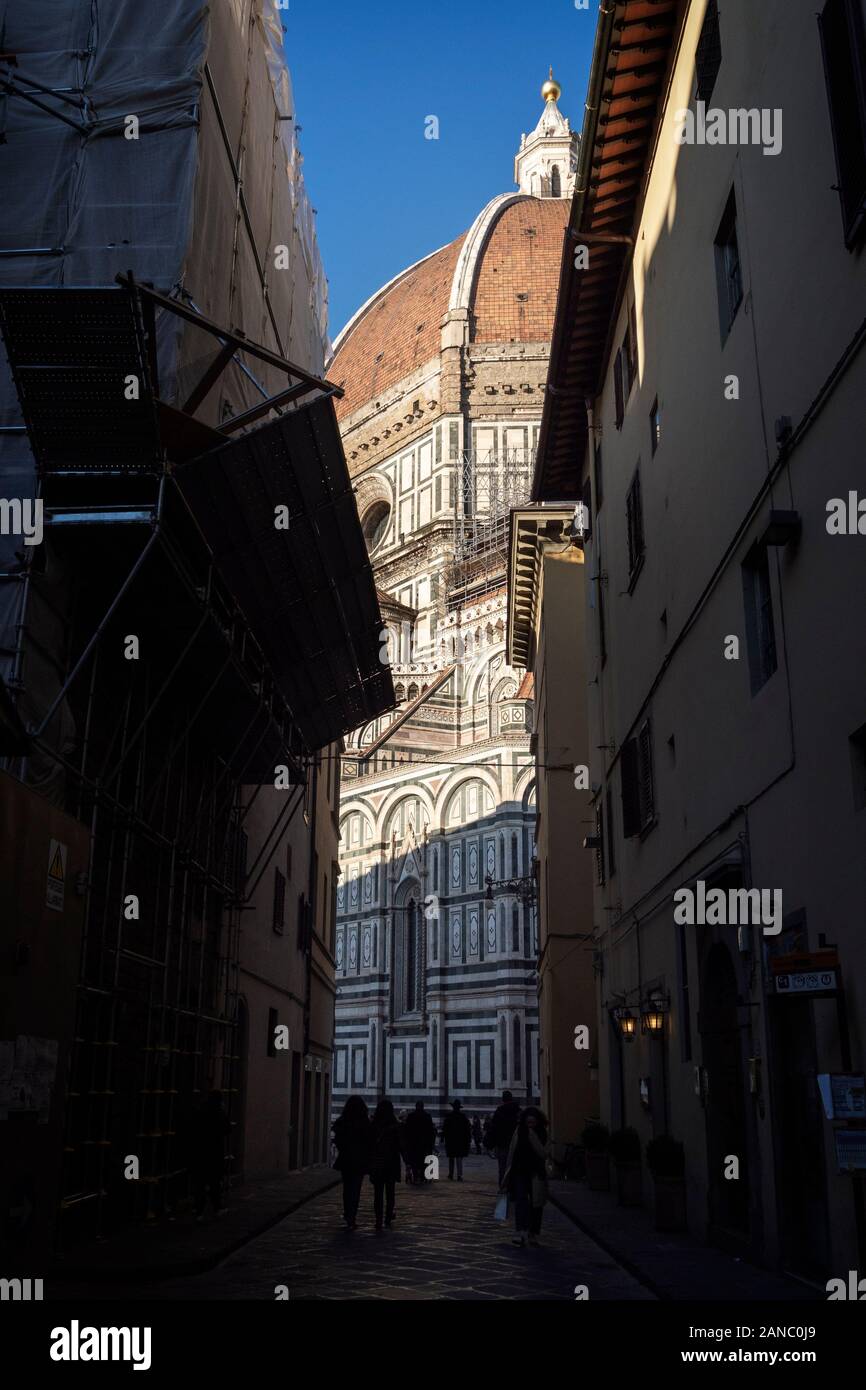 FLORENCE, ITALY -January 6. 2020: Glimpse of the Duomo, aka Basilica di Santa Croce in Florence, Tuscany. With tourists enjoying winter sunshine. Stock Photo