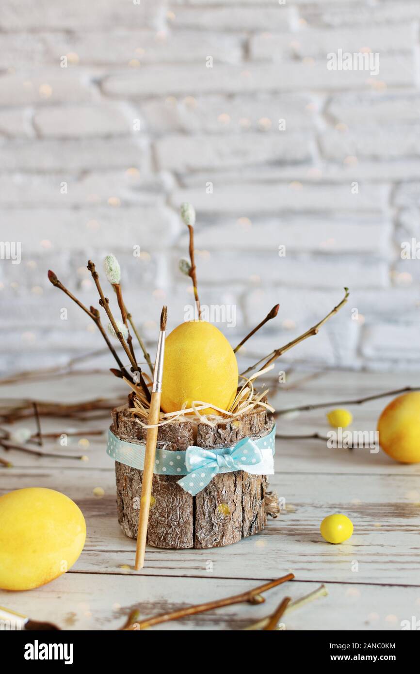 Yellow colored Easter eggs on wooden table. Happy Easter time. Creative Easter decoration. Stock Photo