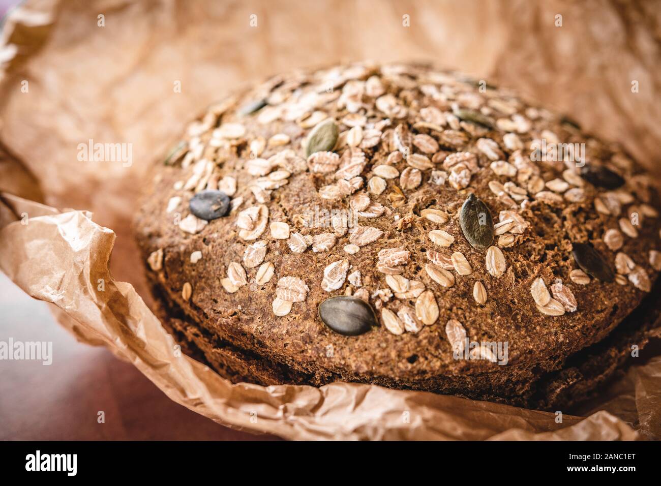 Whole Grain Traditional Rye Bread in Brown Parchment Paper Stock Photo
