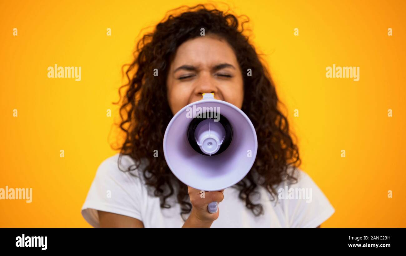 AfricanAmerican woman using megaphone for protest, public opinion