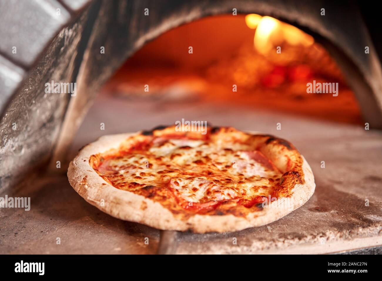 Baked tasty margherita pizza in Traditional wood oven in Naples
