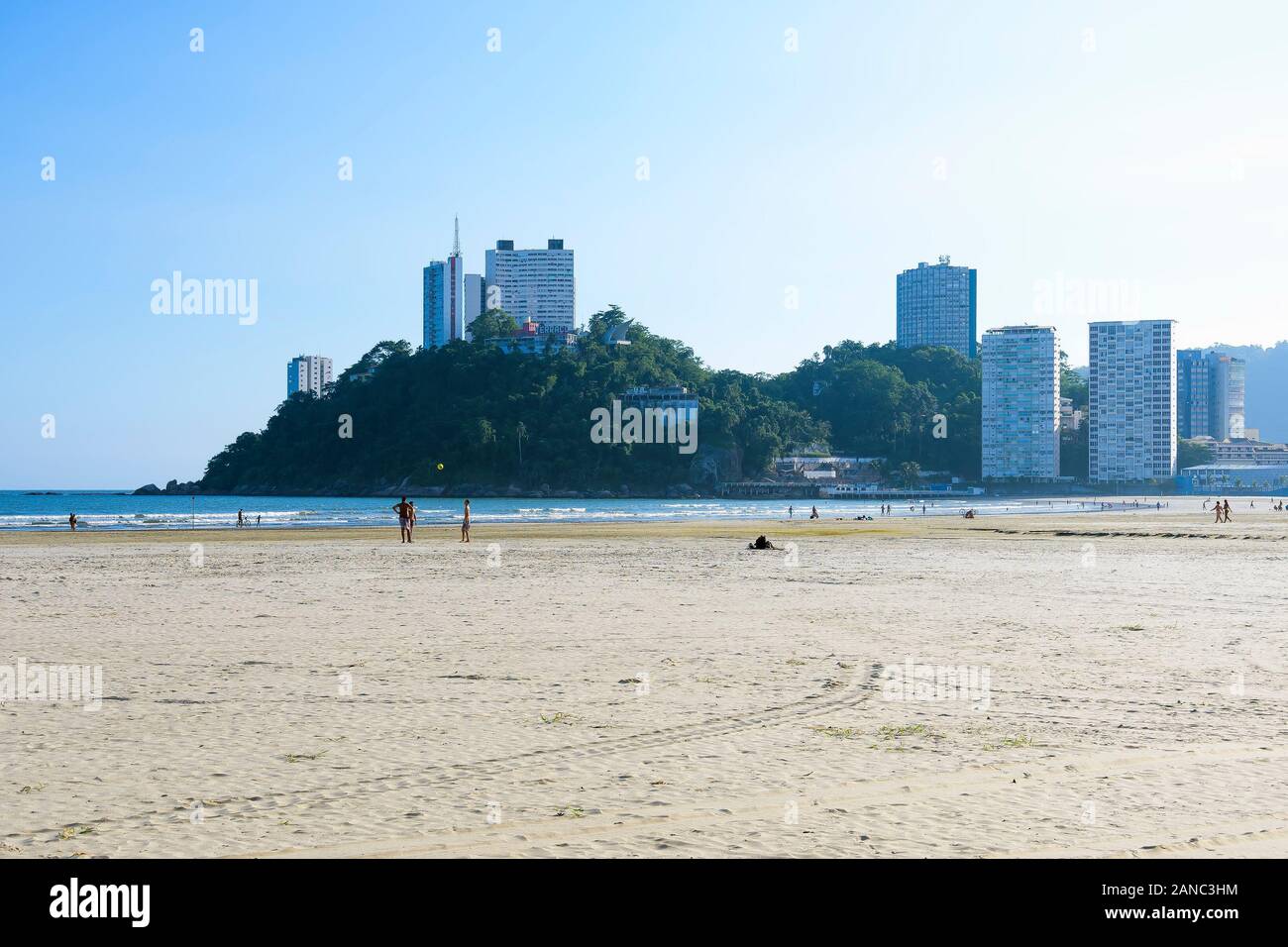 Sao Vicente - SP, Brazil - November 21, 2019: View of Praia do Itarare beach and the Ilha Porchat island on the background. People on the beach on a s Stock Photo