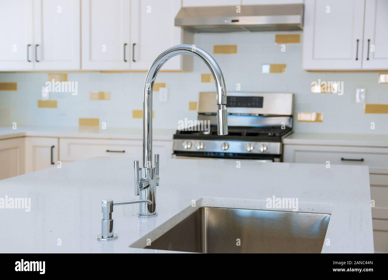 Modern domestic kitchen cabinets with new appliances and sink in ...