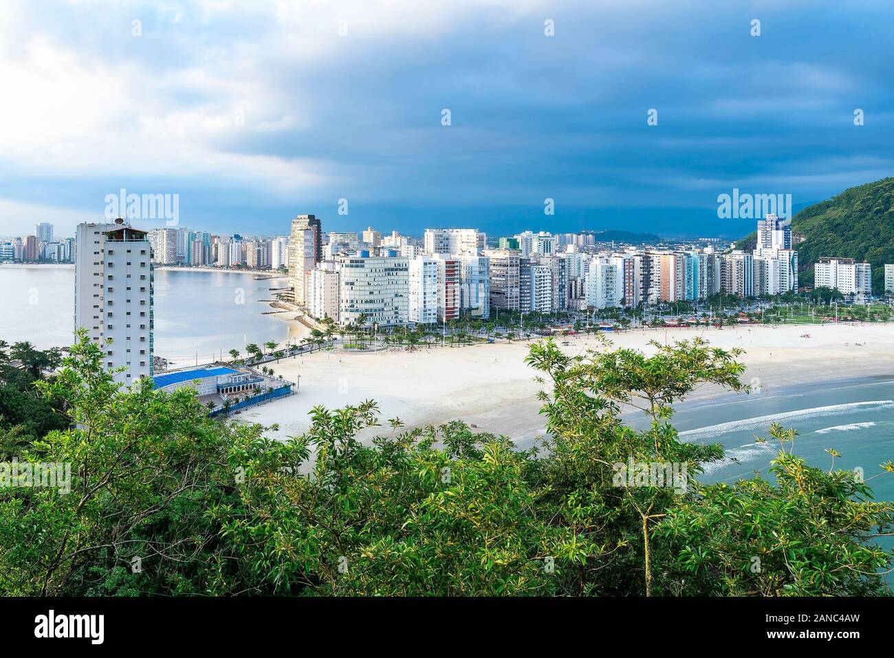 Coastal city with many tall buildings near to the beach. Aerial view of Sao Vicente city, SP Brazil. The beaches of Itarare, Milionarios and Gonzaguin Stock Photo