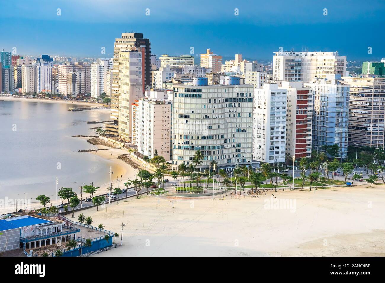 Coastal city with many tall buildings near to the beach. Aerial view of Sao Vicente city, SP Brazil. The beaches of Itarare, Milionarios and Gonzaguin Stock Photo