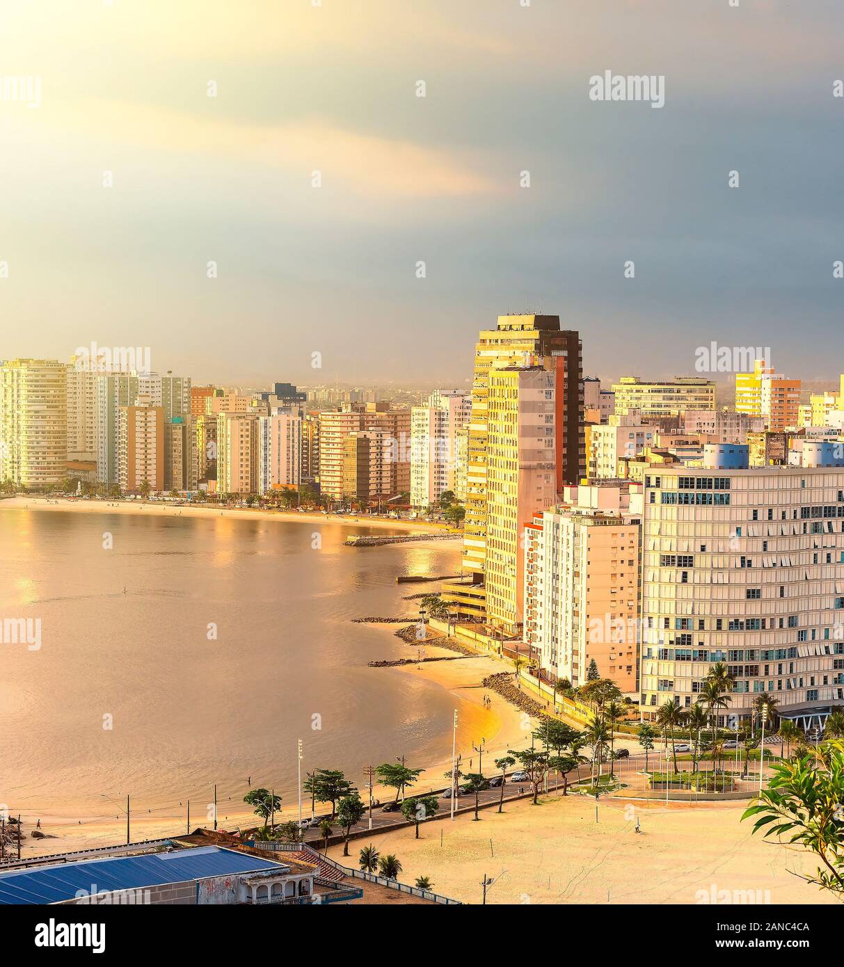 Panoramic aerial view of Sao Vicente city, SP Brazil at a beautiful golden hour sunset. The beaches of Itarare, Milionarios and Gonzaguinha, Paulista Stock Photo