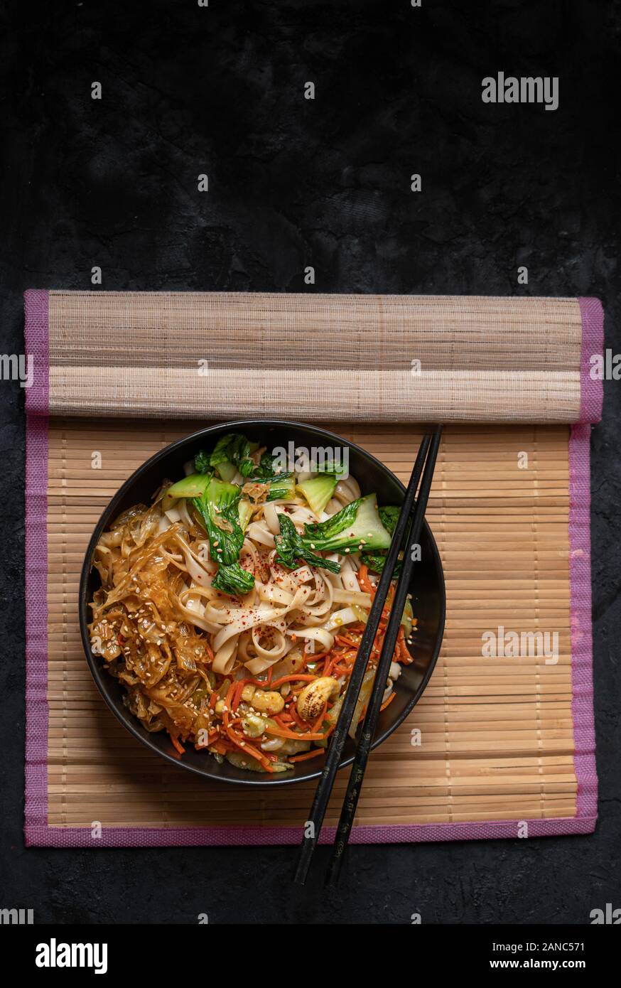 Vegan stir fry consisting of yuba, carrot, bok choy and noodles, served