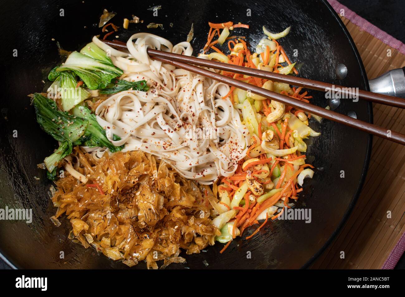 Vegan stir fry consisting of yuba, carrot, bok choy and noodles, served