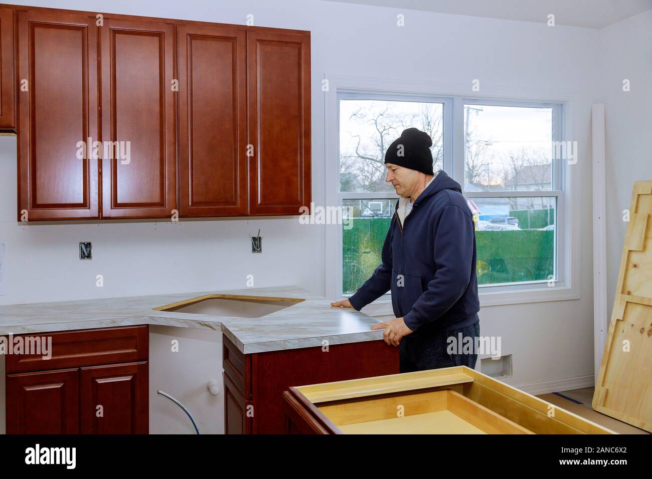 Kitchen counter top in a kitchen carpenter installing more