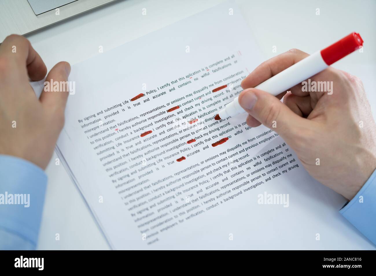 Close-up Of Red Pencil Marking Error During Spellchecking Text On Paper Document Stock Photo