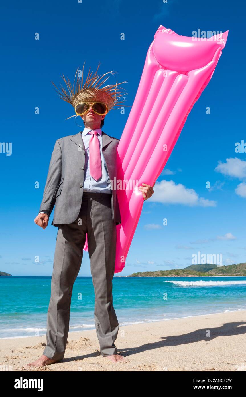 Happy businessman wearing straw hat and oversized sunglasses jumping
