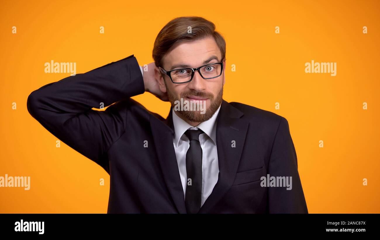Confused businessman scratching head, hopeless situation, lack of knowledge Stock Photo