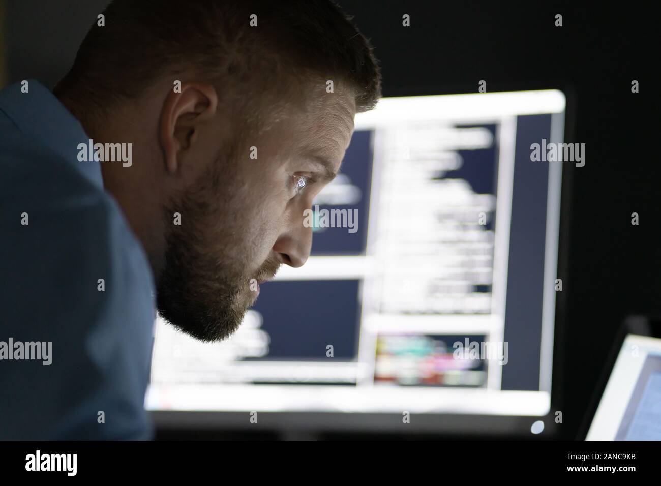 Programmer Working Late At Night On Multiple Computer Screens Stock ...