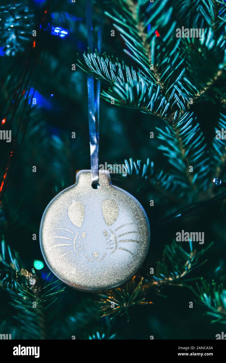 White gingerbread with the symbol of the year 2020 rat. Christmas tree and lights. Chinese New Year. Stock Photo