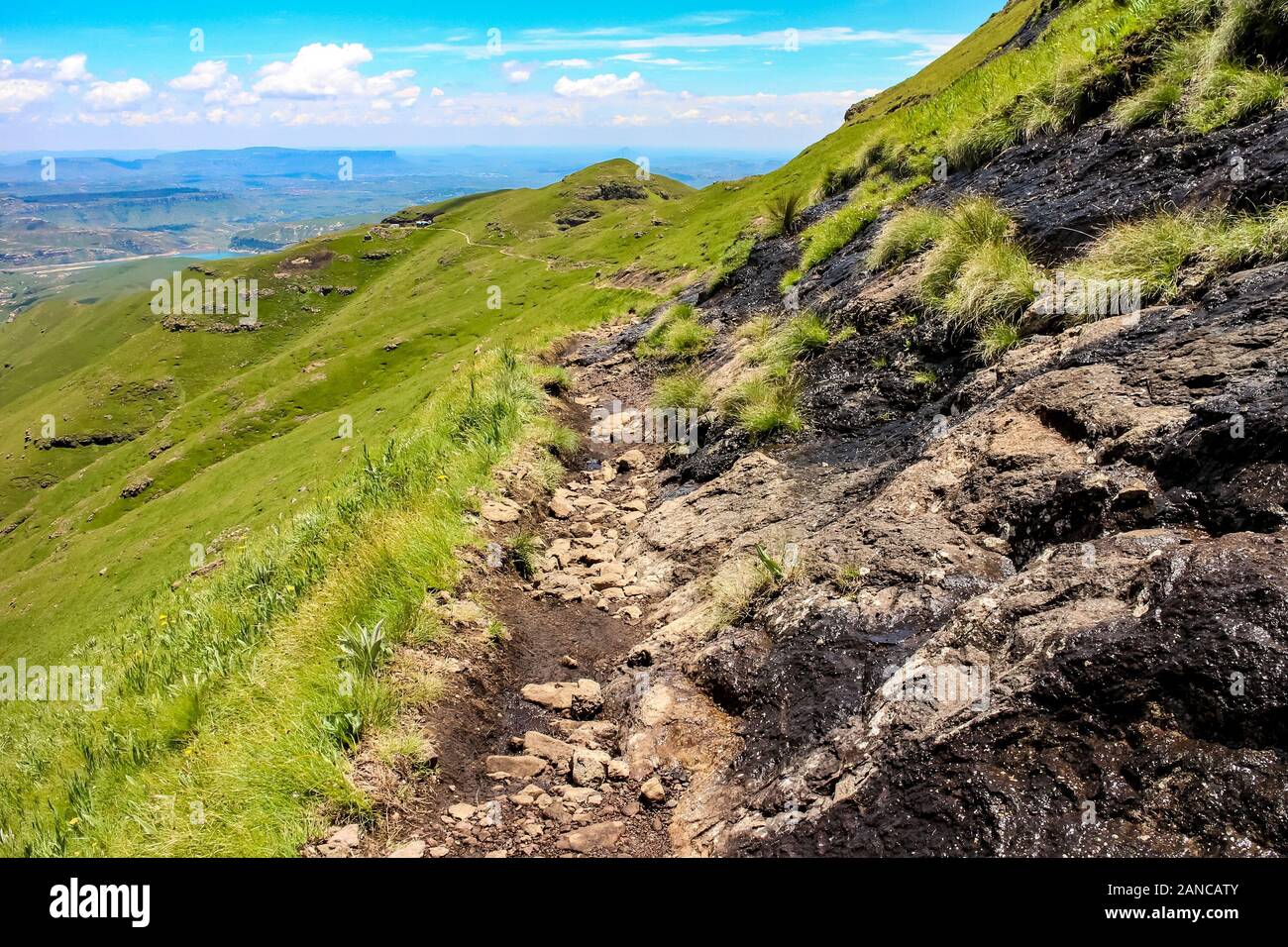 A narrow hiking path in the Drakensberg mountains of Lesotho, Southern Africa. Stock Photo