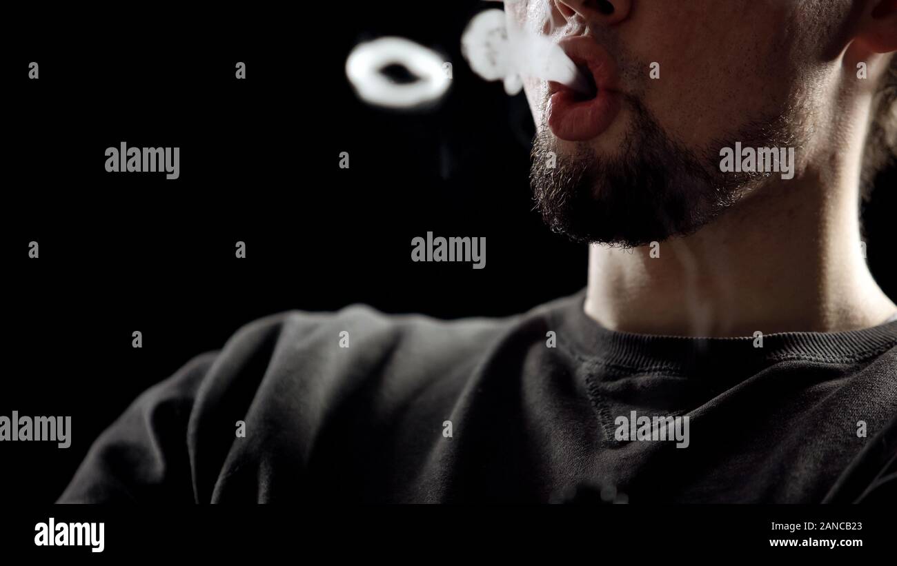 Man blowing smoke rings hi-res stock photography and images