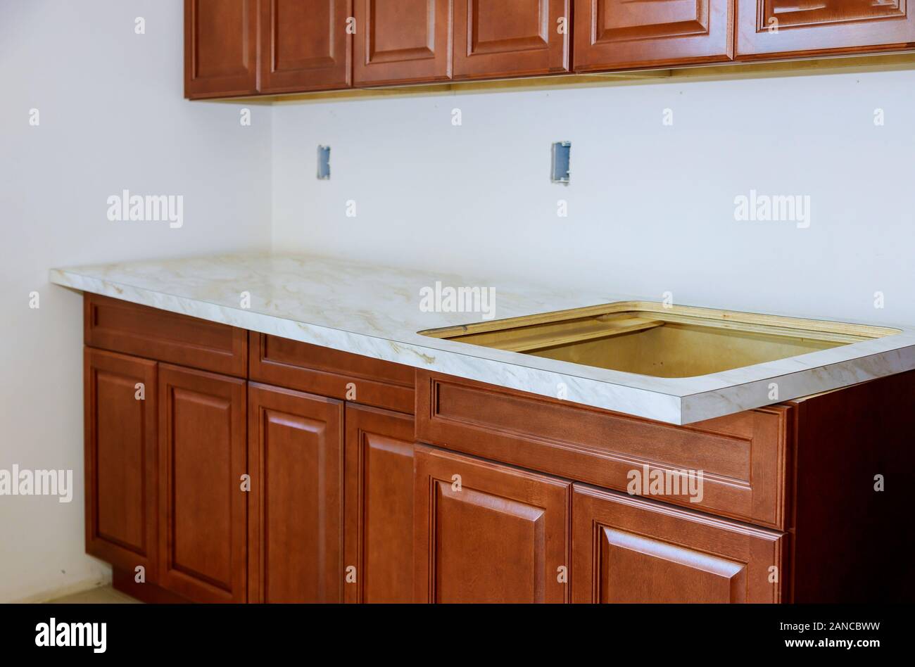 Installing A New Laminate Kitchen Counter Top In A Kitchen Stock