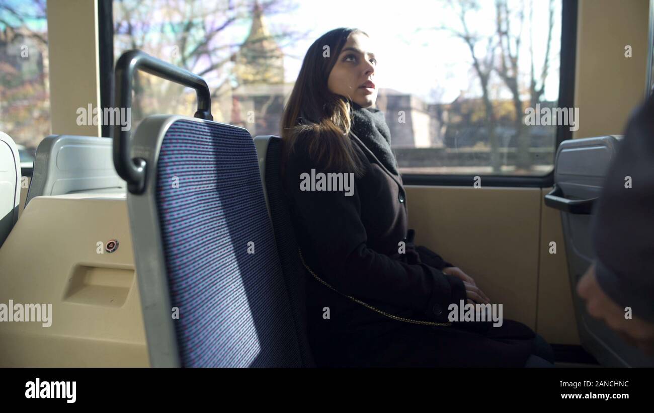 Bus conductor checking female passenger ticket, public transportation, travel Stock Photo