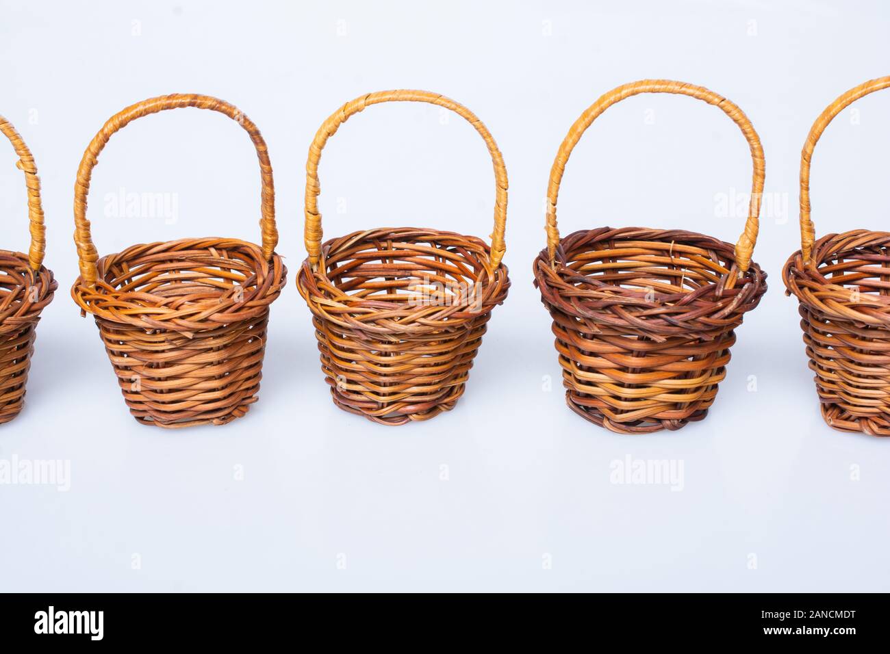 Little size Empty wicker baskets on white background Stock Photo - Alamy