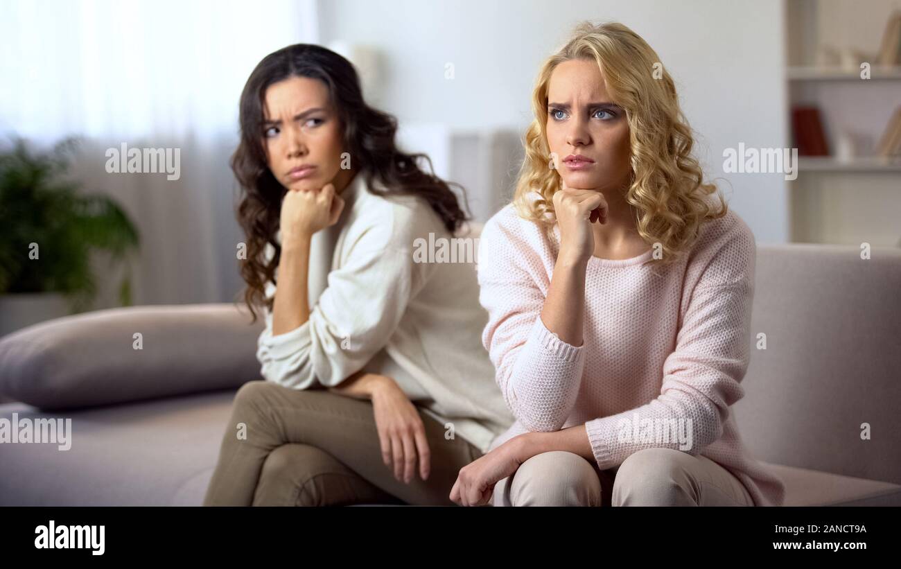 Young woman wants to reconcile with friend, angry after conflict, relations Stock Photo