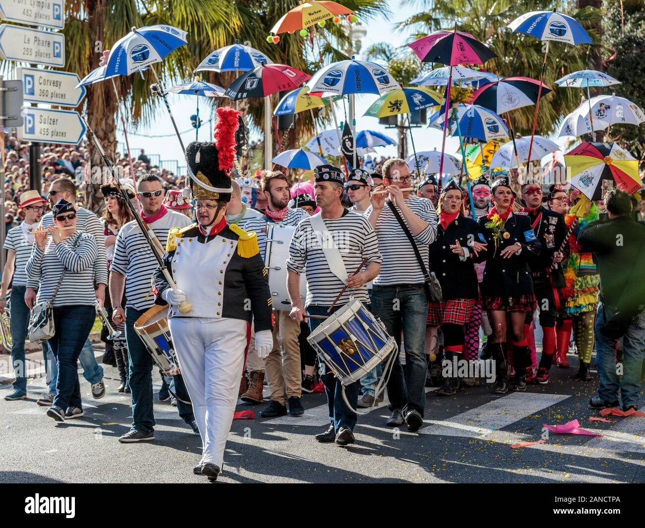 Marching band with umbrellas at the Flower Parade, Nice Carnival, French Riviera, Cote d'Azur, France. Stock Photo