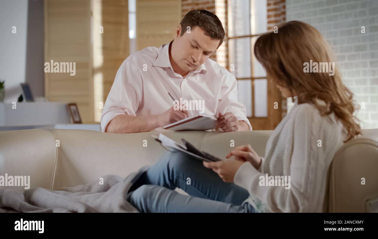 Serious young couple planning family budget, calculating costs of