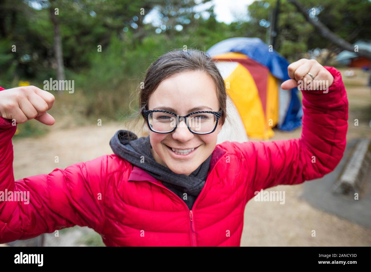 Portrait of female camper showing off her muscles. Stock Photo