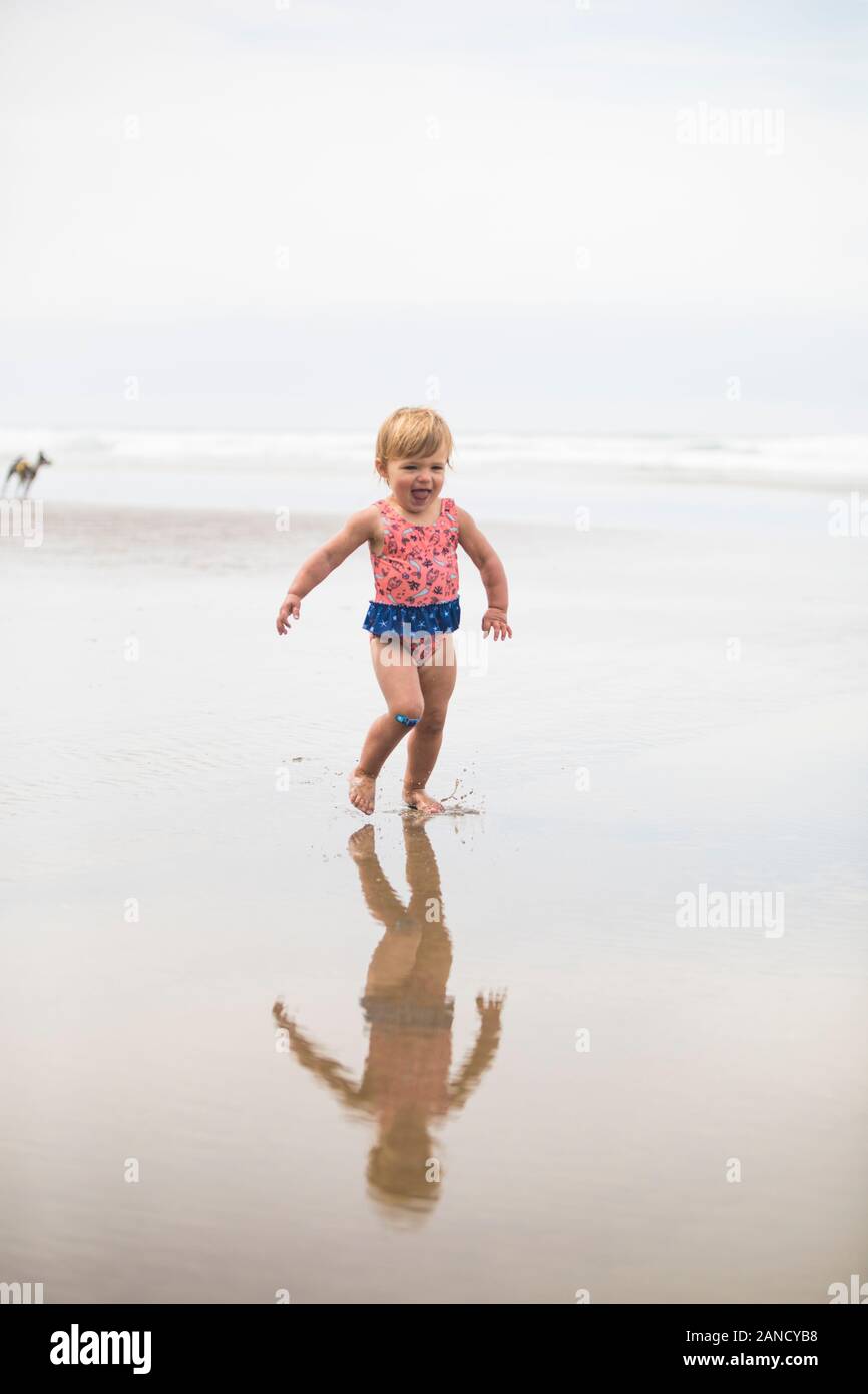 Girl running, laughing on the beach Stock Photo Alamy