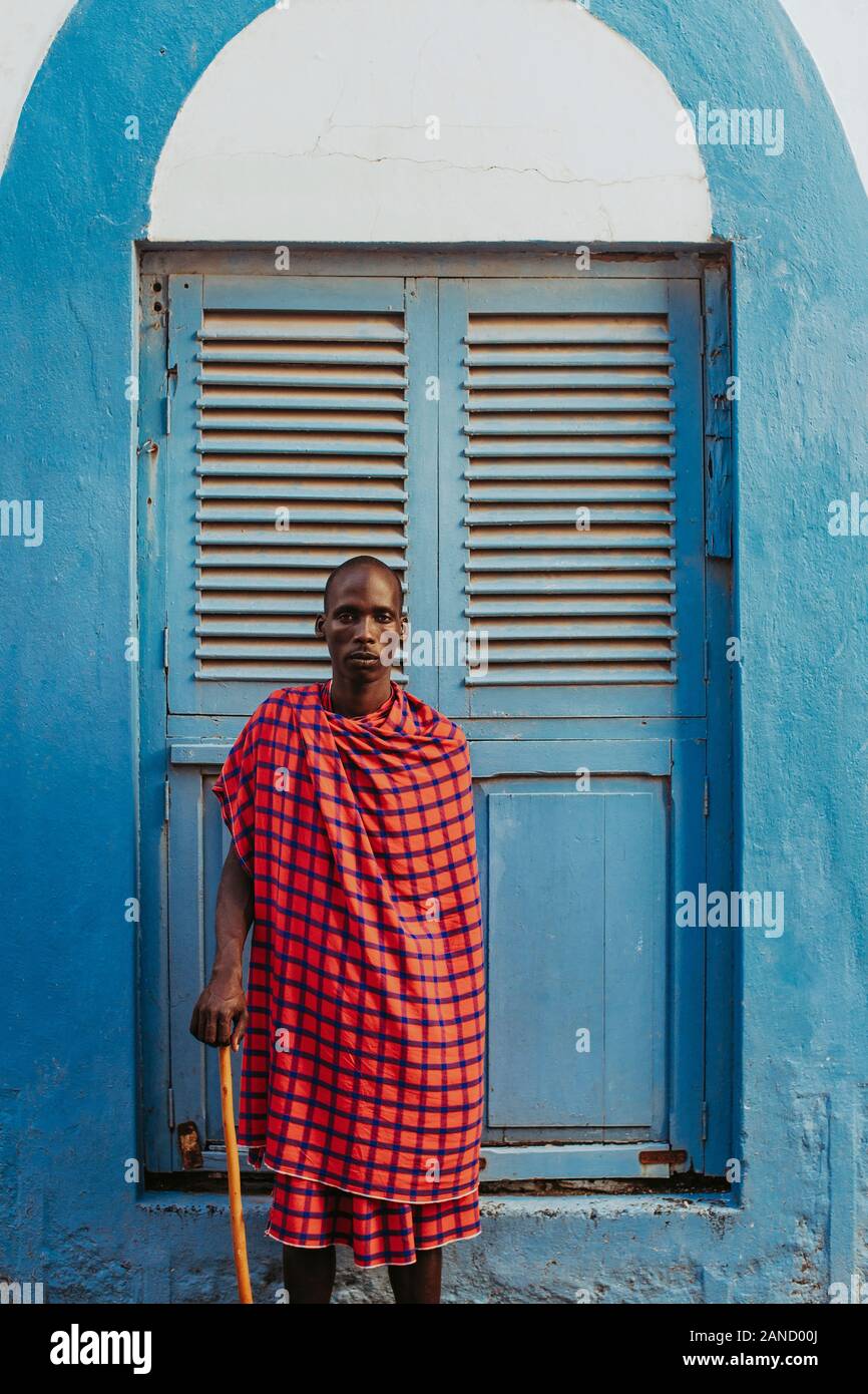 Masai men standing in front of a traditional door in old town Stock Photo