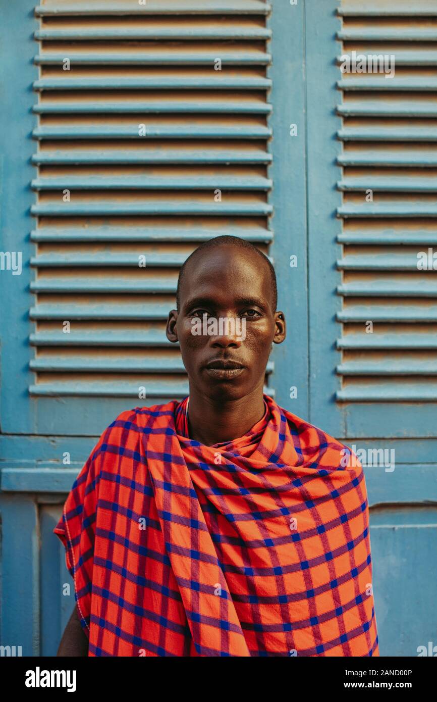 Masai men standing in front of a traditional door in old town Stock Photo