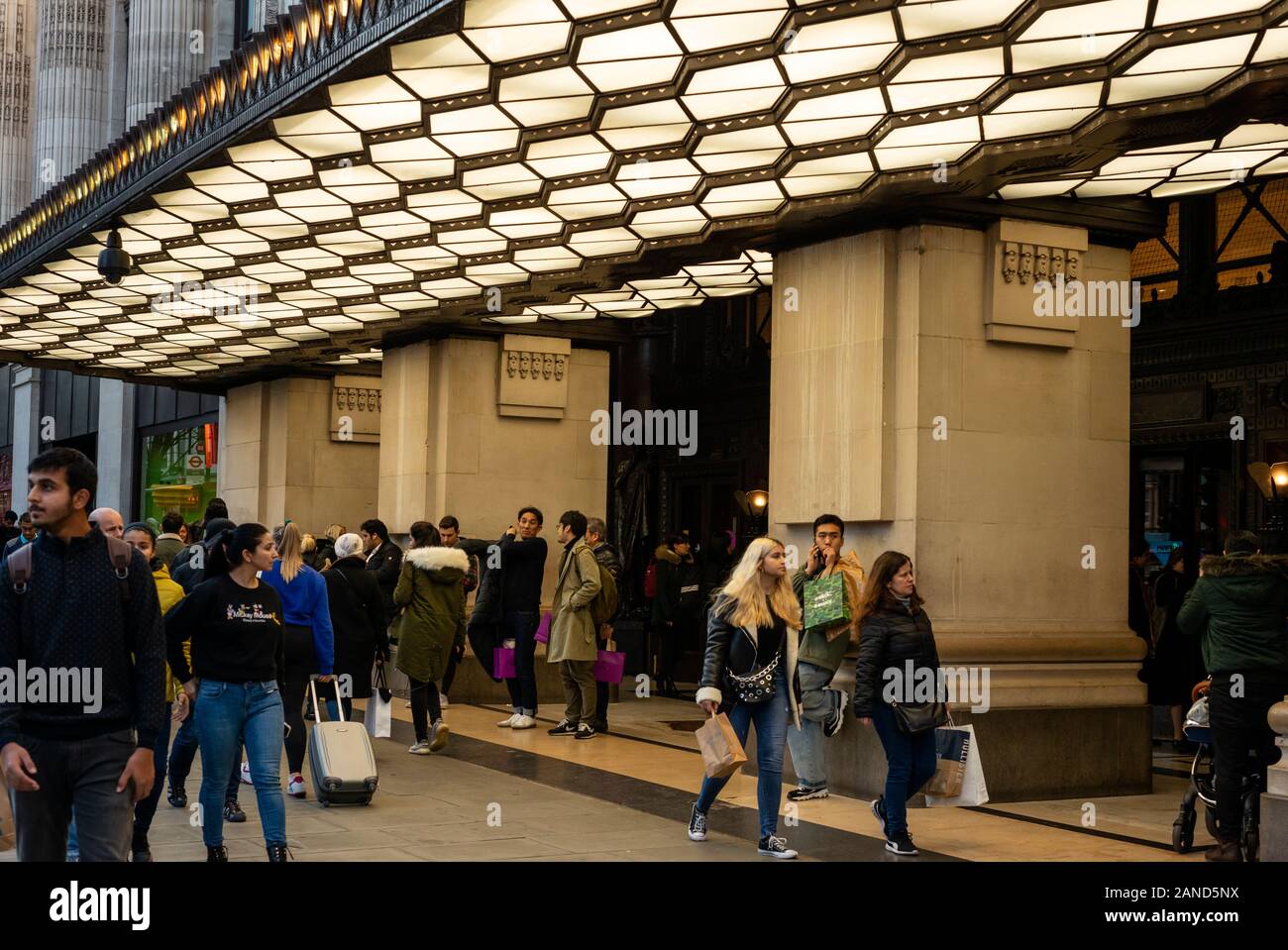 Selfridges London Oxford Street London retail evening view of shoppers people walking past the Selfridges department store entrance in Oxford Street London, UK as of February 2020 Stock Photo