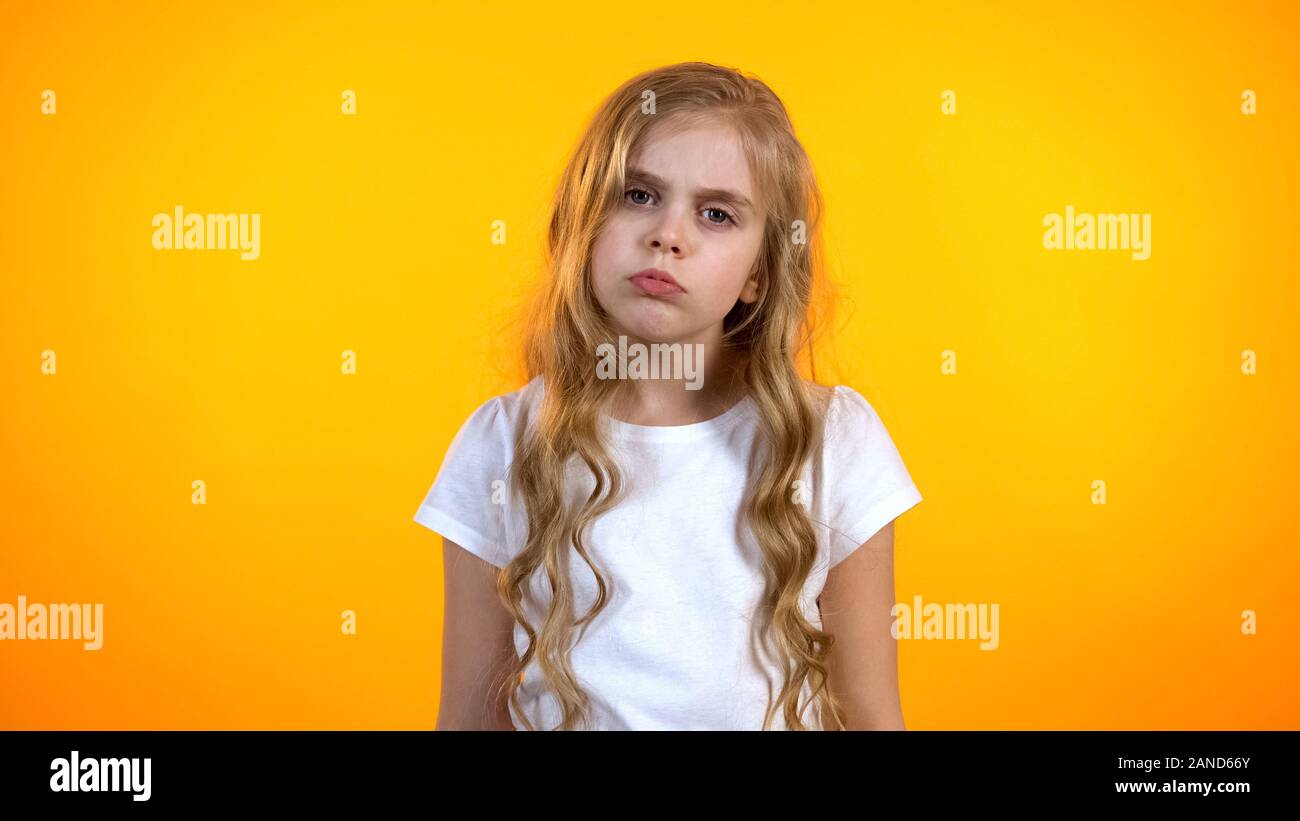 Pretty upset girl frowning and looking to camera, feeling sleepy after school Stock Photo